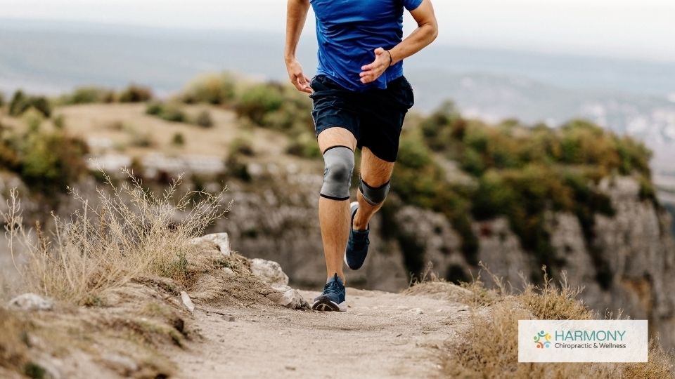 A man running on the trail with knee pads