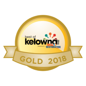A gold medal with the best of kelowna 2 0 1 8 written on it.
