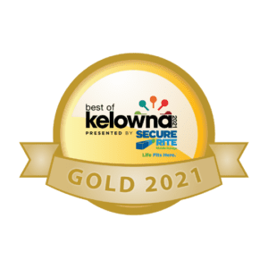 A gold medal with the best of kelowna logo on it.
