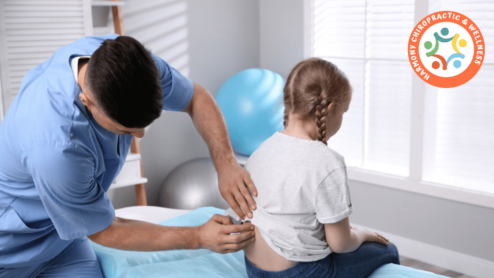 A man is helping a child with her back.