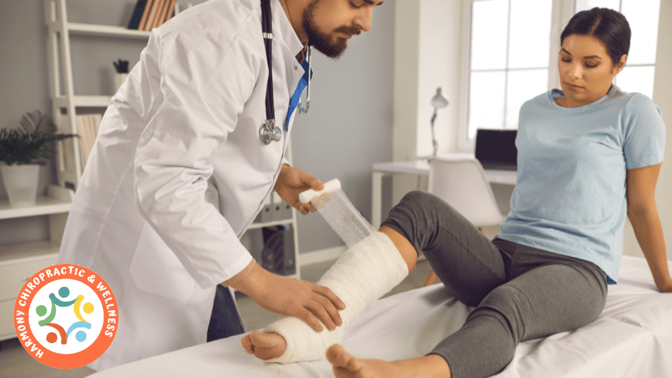 A doctor is bandaging someone 's leg.