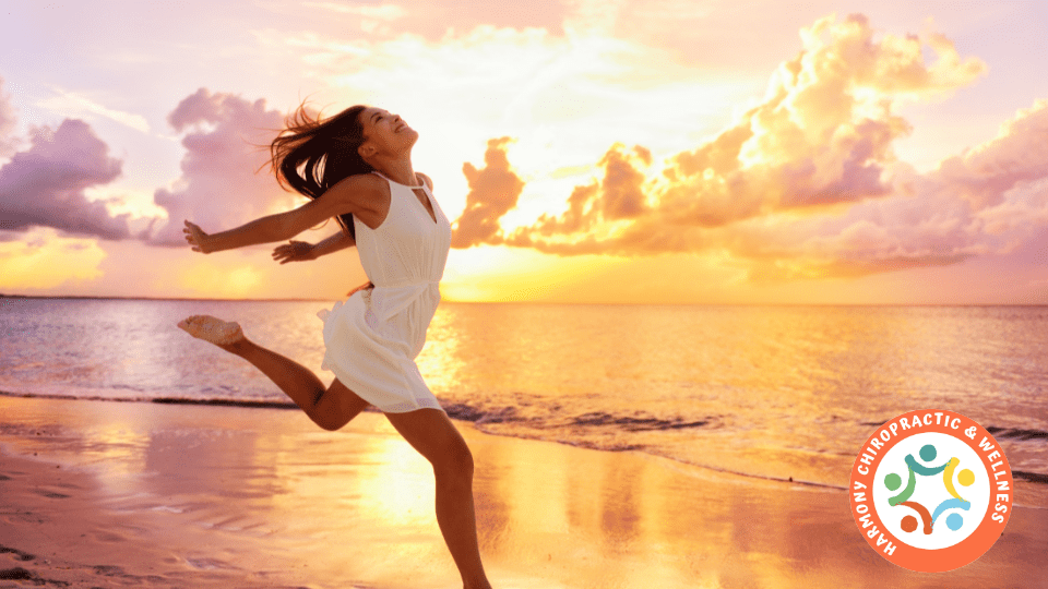 A woman running on the beach at sunset.