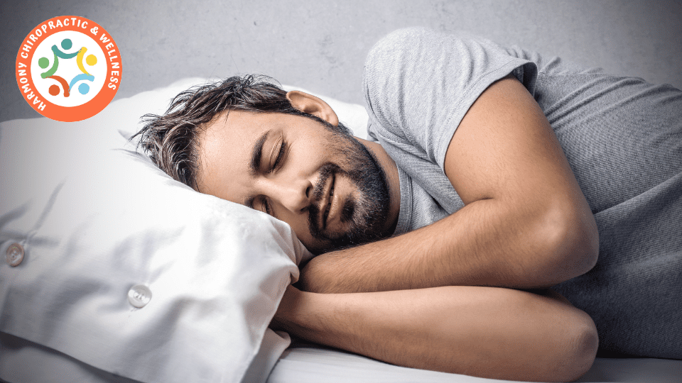 A man sleeping in bed with his eyes closed.