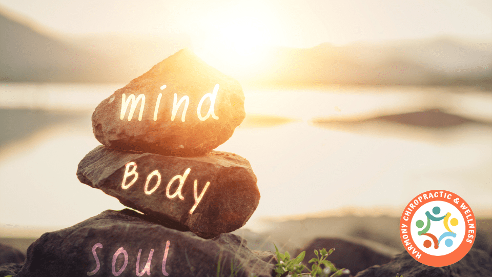 A rock with the words mind body soul written on it.