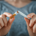 A person is holding a cigarette in their hand.