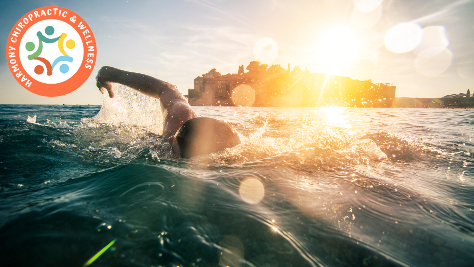 man swimming in the ocean with the sun in the background
